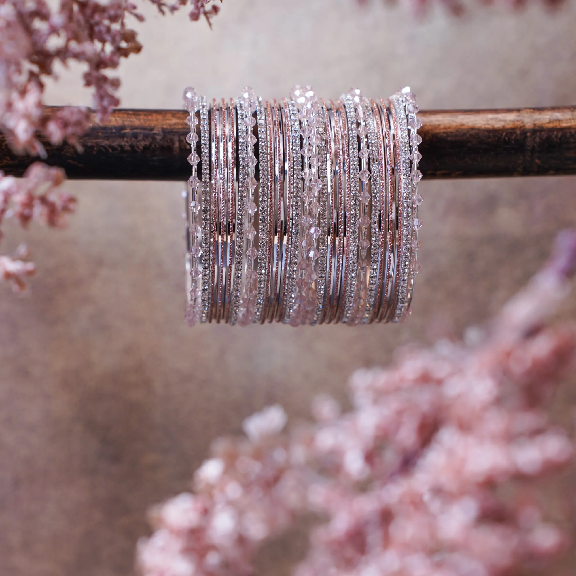 A delicate pink toned stack with fine bangles and subtle shimmer that adds effortless grace. Designed to complement everyday outfits and festive looks with a soft, elegant sparkle.
